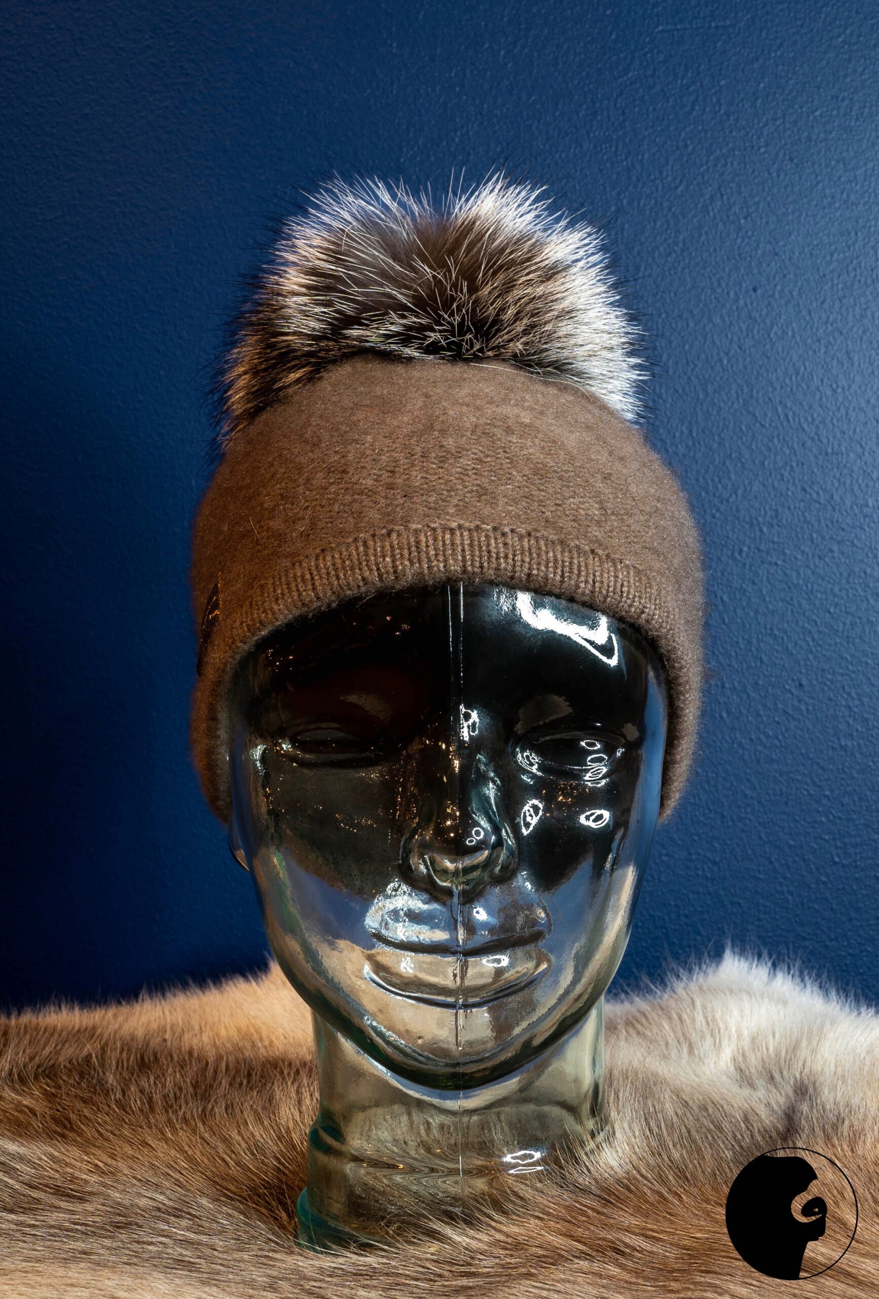 Double-knit hat in musk ox wool with a fox pom-pom